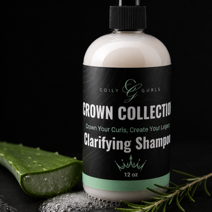 Bottle of Coily Gurls Crown Collection Clarifying Shampoo with aloe vera leaf and rosemary on a dark background