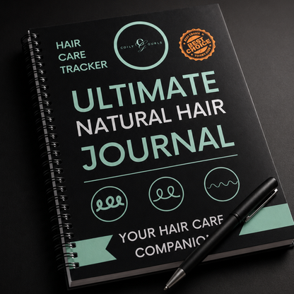 Ultimate Natural Hair Journal with a pen on a dark background