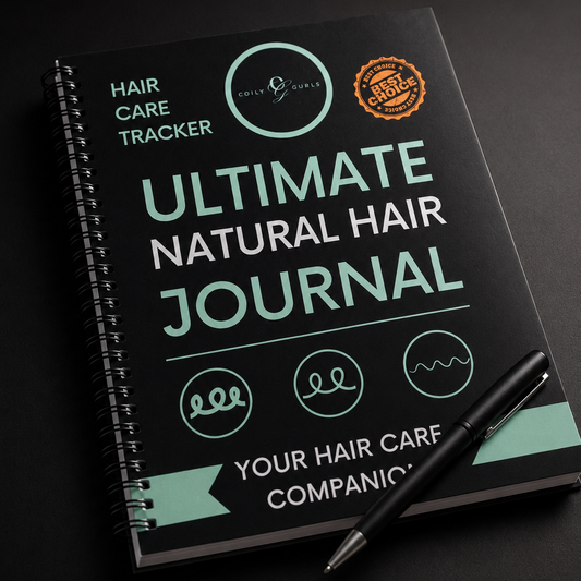 Ultimate Natural Hair Journal with a pen on a dark background